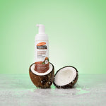 Coconut Hydrate Foaming Cleanser nestled in coconut with water splashes.