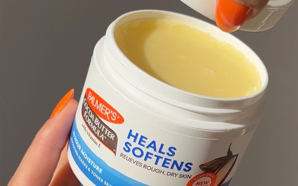 Palmer's Cocoa Butter Formula Original Solid Jar, held in woman's hand, is the ideal cocoa butter for cracked heels product
