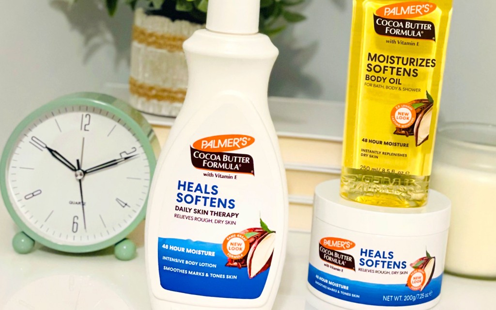 Palmer's Cocoa Butter Formula winter skin care products on vanity table with clock