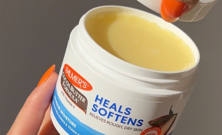 Palmer's Cocoa Butter Formula Original Solid Jar, held in woman's hand, is the ideal cocoa butter for cracked heels product