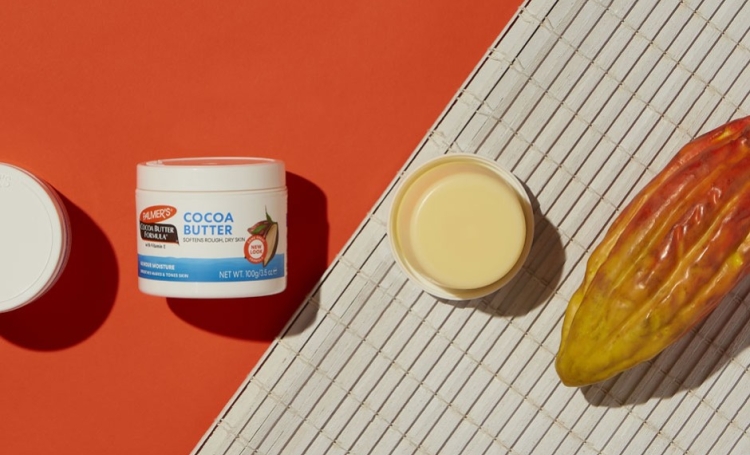 Many Palmer's Cocoa Butter Formula Original Solid Jars, the best dry skin solution, on a table with one jar open